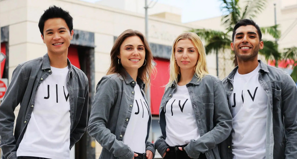 Stylish white Jiv t-shirts under gray denim jackets at trade shows to generate great revenue