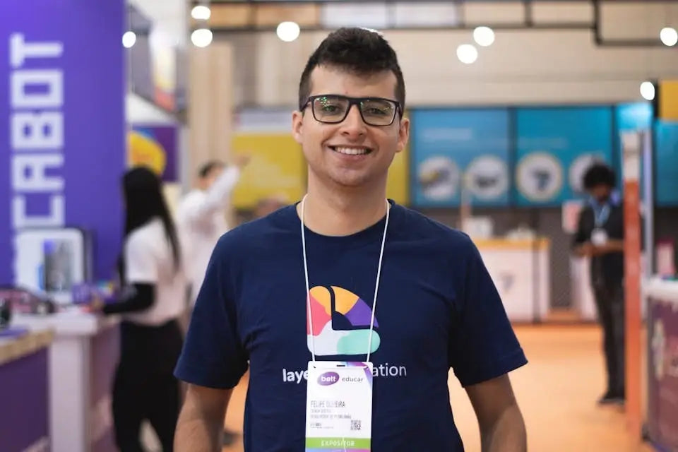 Person in navy blue Layer Education t-shirt at first-time trade show event