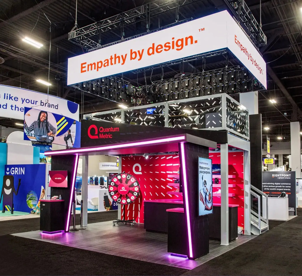 Sleek black and red Quantum Metric booth with purple neon accents, product demo station