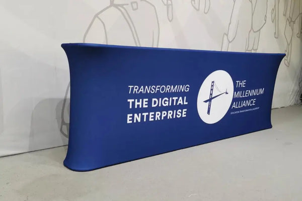 Blue 10ft Straight Tension Fabric Counter with Transforming the Digital Enterprise banner and Millennium Alliance logo