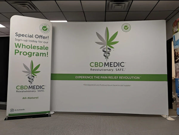 CBD Medic white and green banners with cannabis caduceus logo on 10ft display