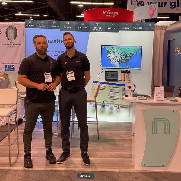 Two men in black polos at 10x10 Frameless SEG Lightbox TV Display booth