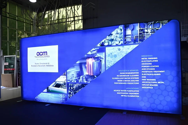 Blue ACM Technologies industrial solutions on 20ft backlit tension fabric display