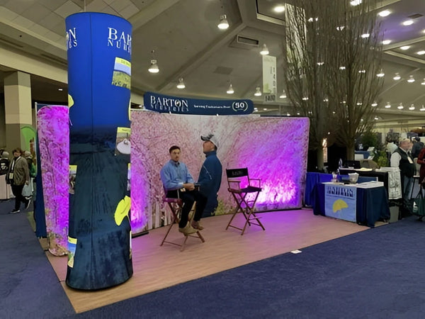 Blue Barton branded cylindrical banner on 20ft curved tension fabric display