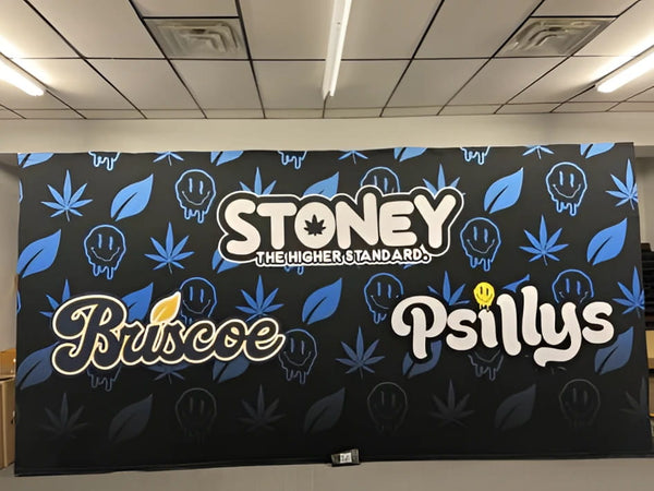 Black banner with blue cannabis leaf, smiling faces, Stoney the Higher Standard text, Briscoe and Psillys logos for 20ft pop up display