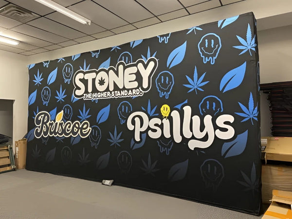 Black foam mattress with blue cannabis leaf patterns and Stoney branding on 20ft pop up display