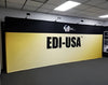 Yellow and black edi-usa branded backdrop on 20ft straight pop up fabric display