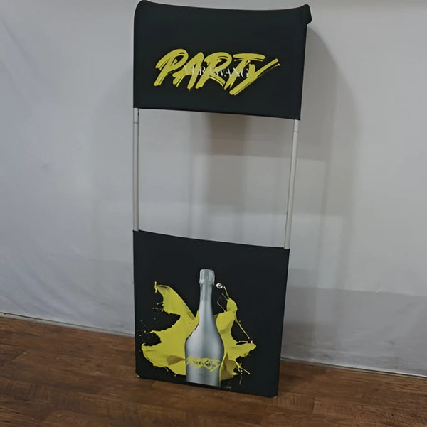 28’’ Partial Waterfall Shelving Display with black fabric stand, yellow cursive party lettering, and silver champagne bottle graphic