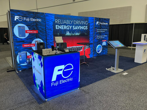 Blue illuminated Fuj Electric trade show booth with SEG lightbox display