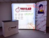 White Toylab illuminated trade show stand with smiling bomb logo