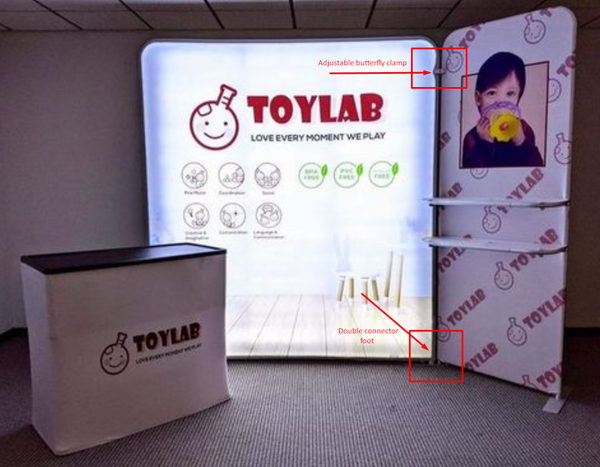 White illuminated Toylab trade show stand with smiling bomb logo