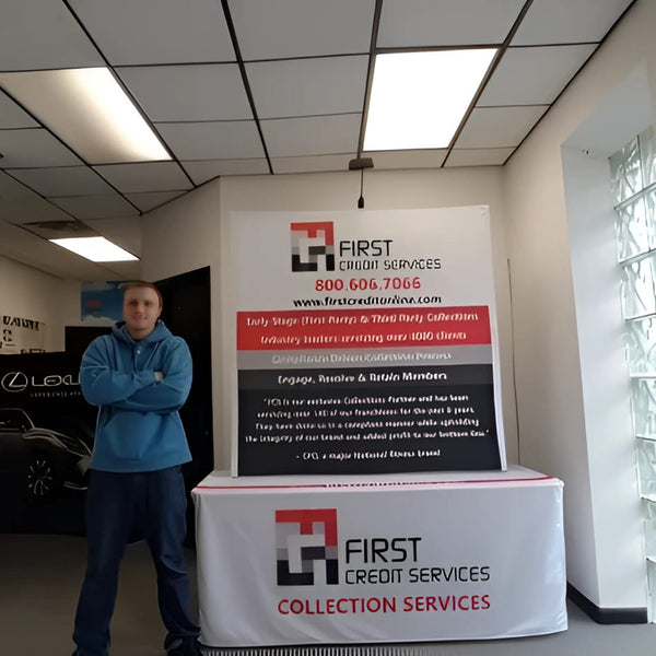 Man in blue hoodie and dark pants by 5ft tabletop pop up display with First Credit Services banner