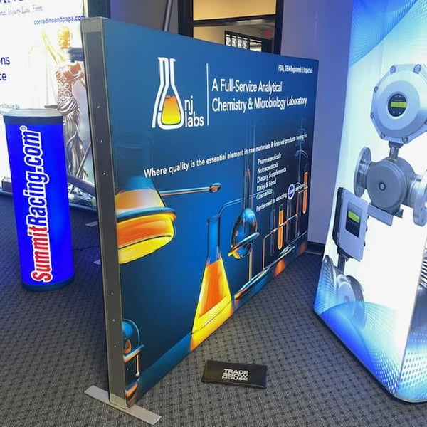 Blue NI Labs promotional banner in 6.5ft frameless SEG lightbox half wall display