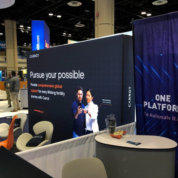 Black Carrot booth with Pursue Your Possible display and people image