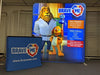 Brave Me animated lion in white coat on 8ft backlit display banner