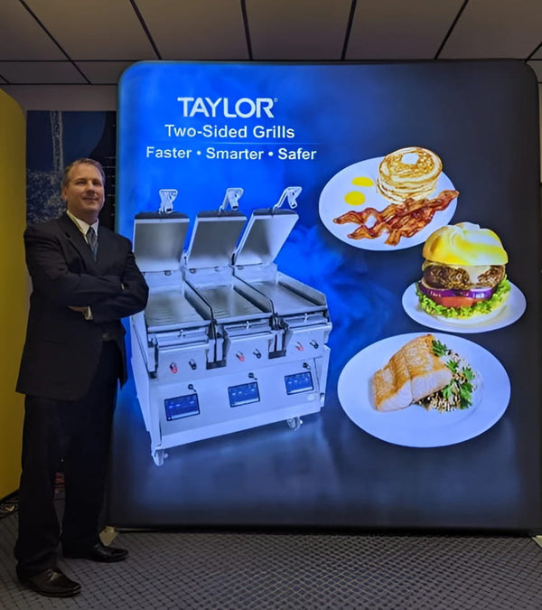 Taylor two-sided grills with stainless steel surfaces in 8ft backlit display