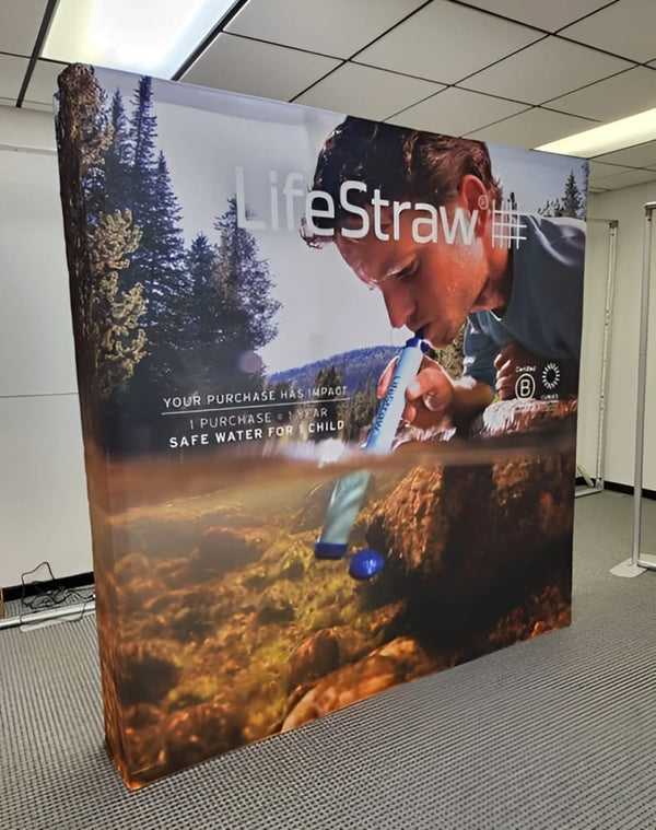 Man using Blue LifeStraw water filter outdoors on 8ft display