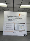 White Binocs scheduling software promo banner on 8ft pop up display