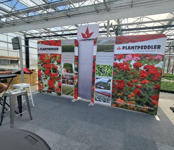 Plantpeddler 8ft Straight Tension Fabric Display Kit with red pink geraniums