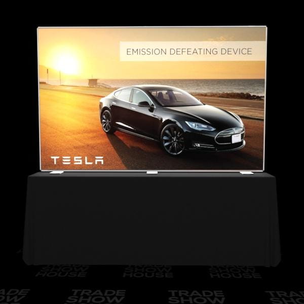 Black Tesla Model S on digital screen with emission defeating device text