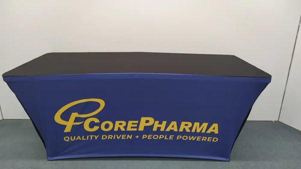 Blue stretch table cover with gold CorePharma logo and tagline