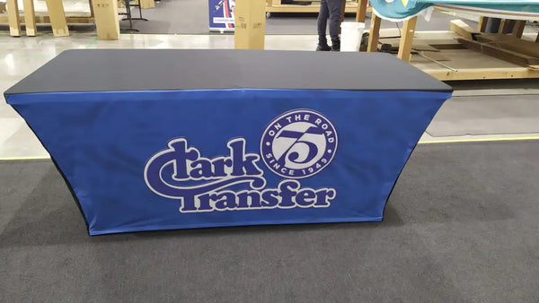 Blue backlit stretch table cover with Clark Transfer logo and 1948 emblem