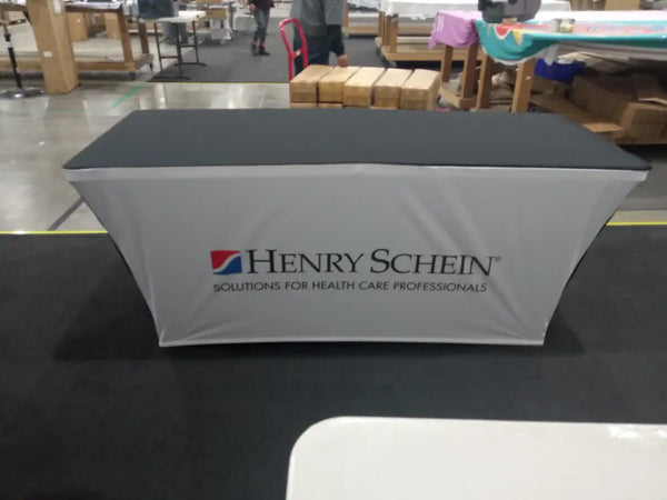 Gray Backlit Stretch Table Cover with Black Trim and Henry Schein Logo