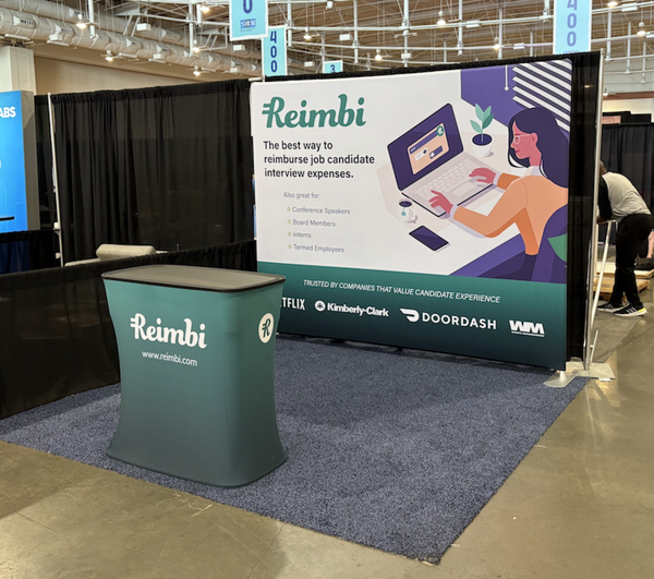 Teal Reimbi booth table with black top and logo in C400 case