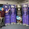 Purple retractable banner stand advertising 2022 National Black MBA Association Women’s Conference