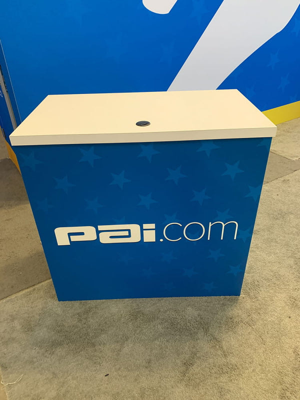 Blue counter top desk grommet with white star pattern and pai.com logo