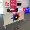 White fabric trade show barrier with colorful rainbow apple logo