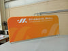 Orange fabric banner with Synergetic Media logo for crowd control barrier