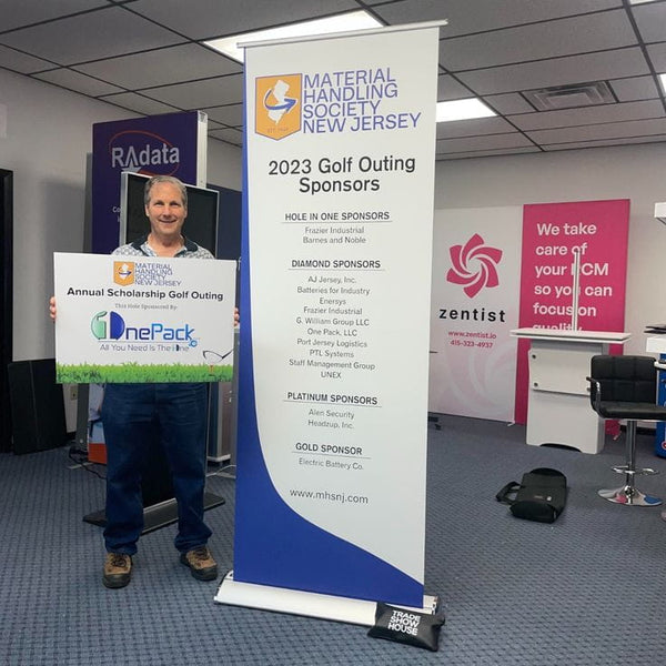 Blue and white roll-up banner with 2023 golf outing sponsor info