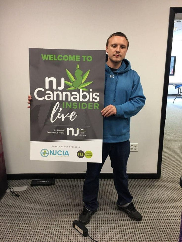 NJ Cannabis Insider Live mounted poster with green text and leaf logo