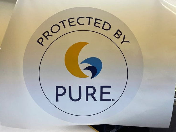 Circular white Protected by Pure sticker with yellow blue logo on mounted poster