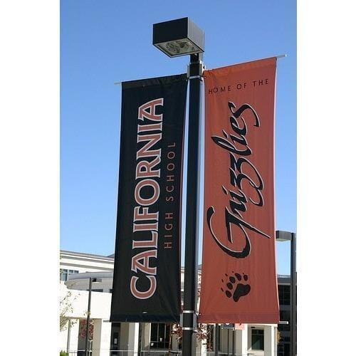 Black and orange California High School Grizzlies outdoor pole banners with paw print logo