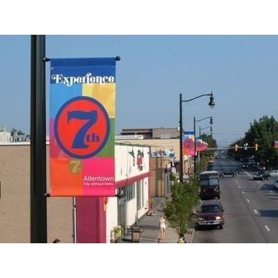 Vibrant multicolored 7th outdoor pole banner with bold blue red circular design