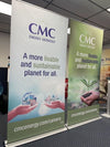 Two premium 48-inch retractable banner stands in white and green with CMC Energy Services logo