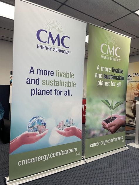 Two premium 48-inch retractable banner stands in white and green with CMC Energy Services logo