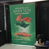 Green Shen Yun 2017 roll-up banner with mid-air dancer in red green costumes