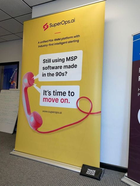 Bright yellow superops.ai banner with pink rotary phone and upgrade MSP text
