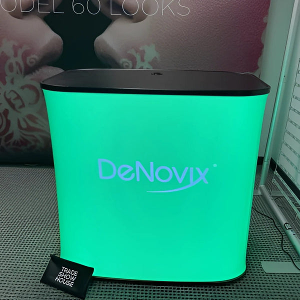 Sleek green glowing DeNovix display on black-topped Rectangle Backlit Inflatable Counter