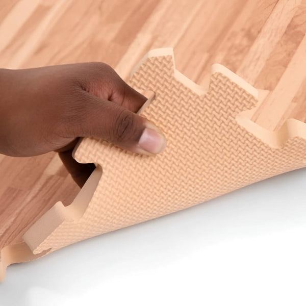 Beige Soft Wood interlocking foam trade show floor mat with textured surface and raised edges