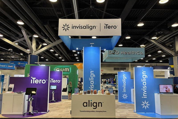 Blue and white Invisalign and iTero branded exhibition booths on square hanging banner