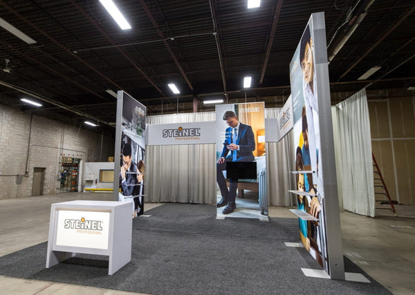 White Steinel logo illuminated on Sync 2-in-1 backlit hybrid exhibit stand