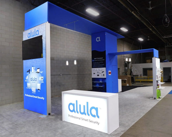 White illuminated alula reception desk with Sync 2-in-1 backlit hybrid kit