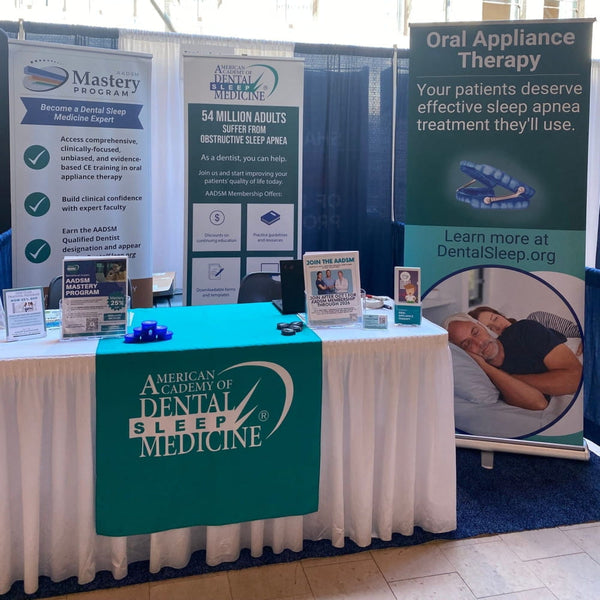 Teal and white table runner with American Academy of Dental Sleep Medicine logo