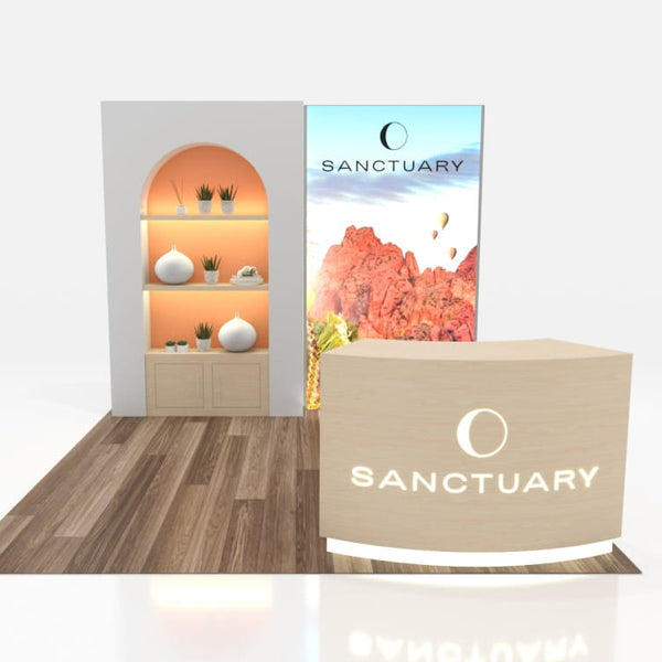 Beige curved reception desk with Sanctuary logo and circular emblem in 10x10 VHE-Modular Inline Exhibit Kit 09a