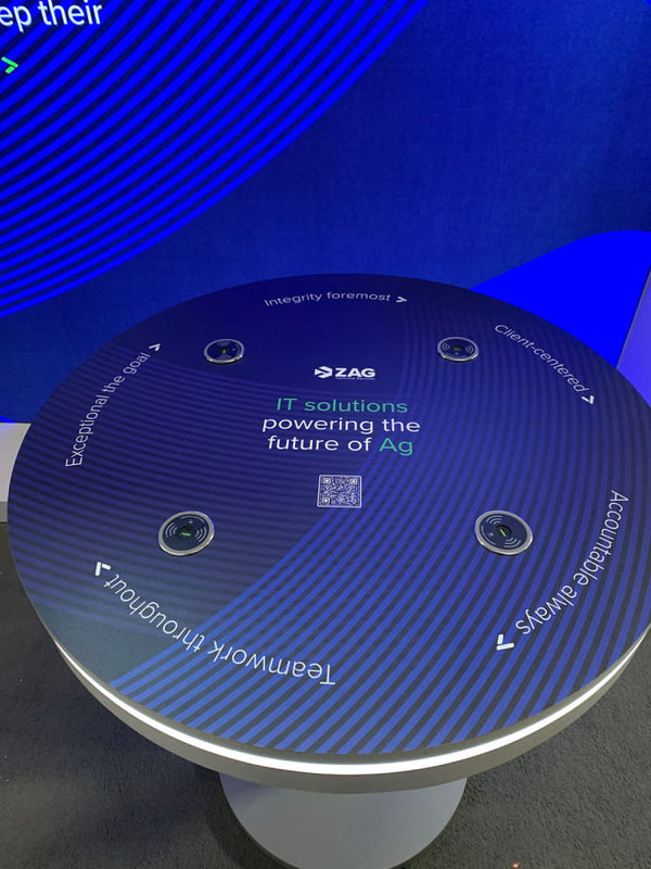 Circular interactive table with ZAG logo and IT solutions text