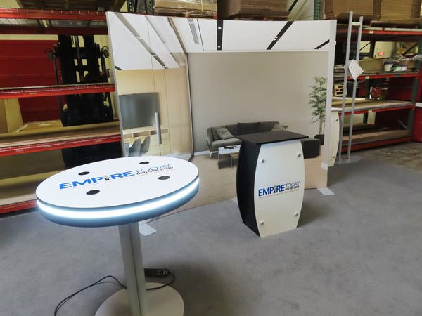 White circular table with glowing blue LED ring and Empire Today logo for wireless charging kit